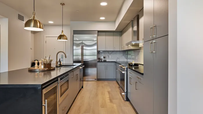 Jade one-bedroom apartment kitchen with modern cabinetry and quartz countertops