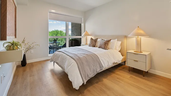 Jade one-bedroom apartment with large window and minimalist decor
