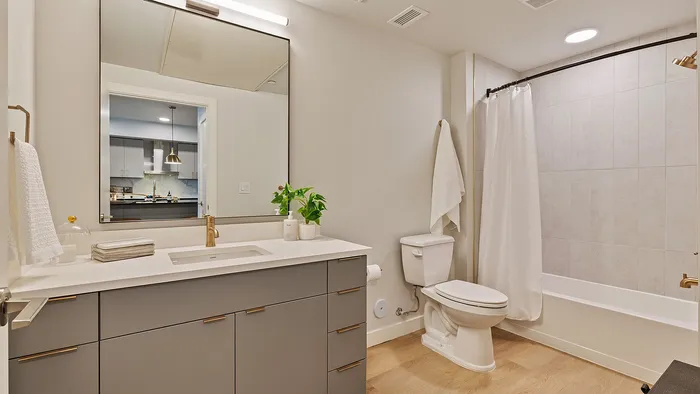 Jade apartment bathroom with tiled shower and contemporary finishes