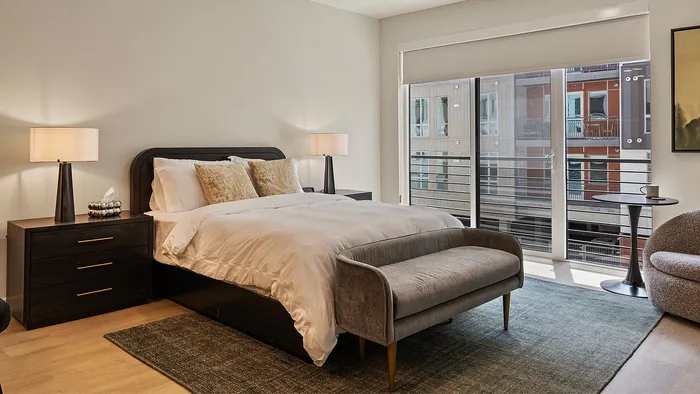 Slate studio apartment living area with sofa and bed in view