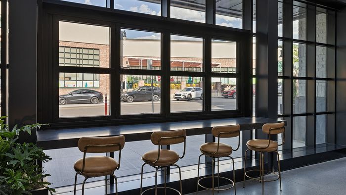 Glass Atrium Lounge at Sugar Alley – glass atrium bench looking out across the street