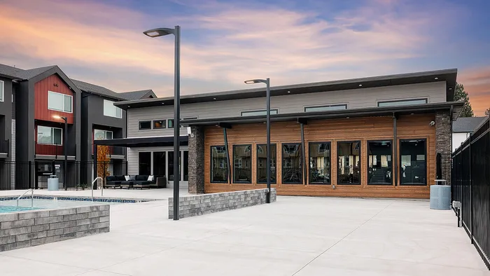 Community clubhouse at RailRunner townhomes featuring modern design, outdoor seating, and a welcoming shared space.