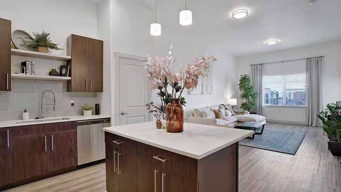 Merritt 1 bedroom apartment kitchen island with open living area at Parkway Lofts in Orem Utah
