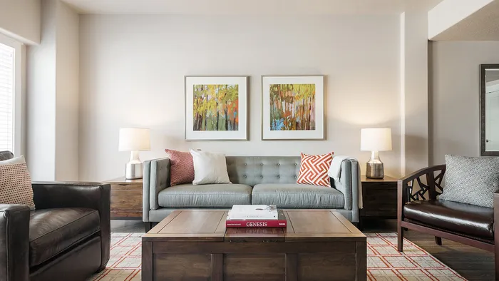 Modern living room with sofa and accent chairs at Junction View Apartments in Ogden, Utah