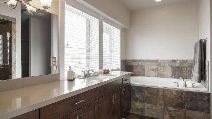 Primary bathroom with soaking tub and dual vanity at Junction View Apartments in Ogden, Utah