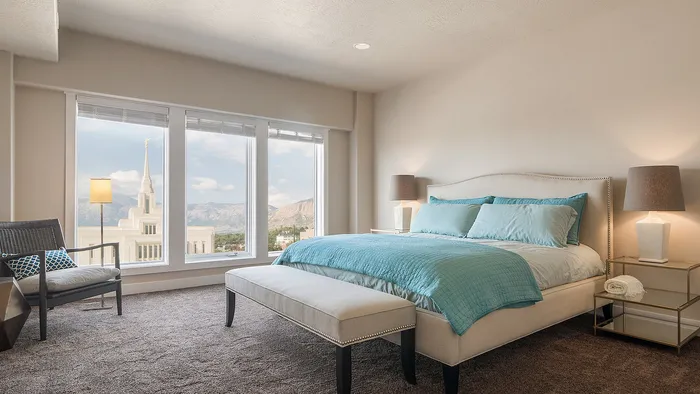 Primary bedroom with mountain views at Junction View Apartments in Ogden, Utah