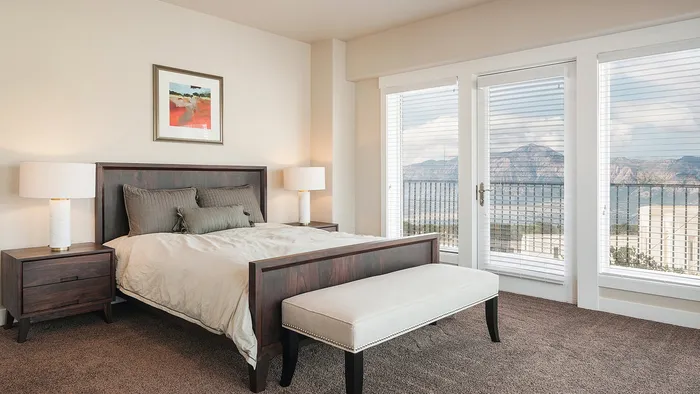 Primary bedroom with mountain views at Junction View Apartments in Ogden, Utah