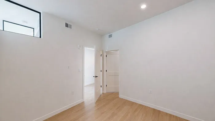 Secondary bedroom with double-door access in Aster two-bedroom apartment at Silo Park