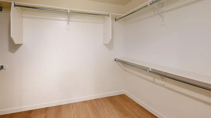 Spacious walk-in closet with built-in shelving in Aster two-bedroom at Silo Park