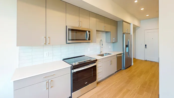 Modern studio kitchen with stainless steel appliances in Bluebell floor plan at Silo Park