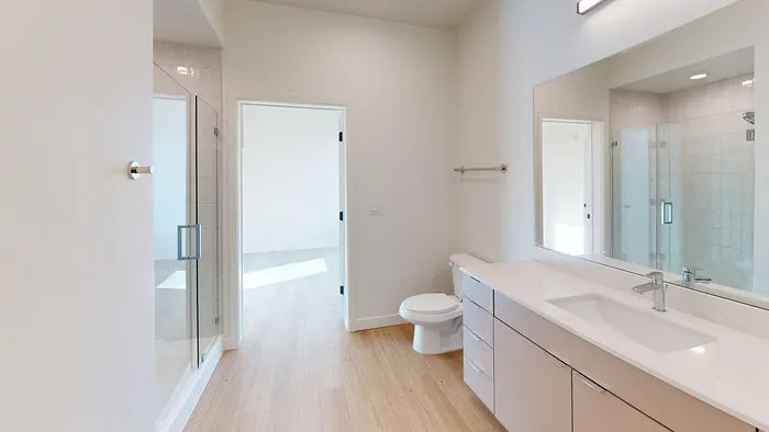 Contemporary bathroom with glass shower and modern finishes in Aster two-bedroom at Silo Park