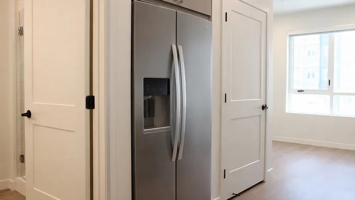 Stainless steel refrigerator and hallway in Sego studio apartment at Silo Park