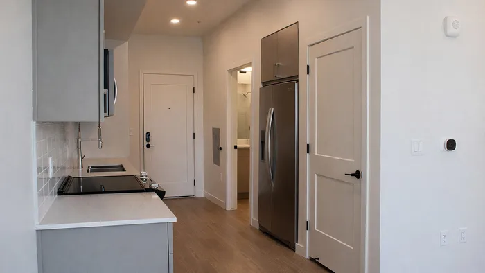 Modern studio kitchen with stainless steel appliances and quartz countertops in Sego at Silo Park