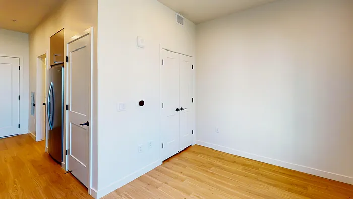 Spacious studio living area with wood floors in Sego apartment at Silo Park