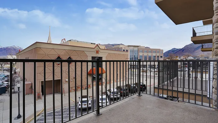 Private balcony at Junction View Apartments overlooking downtown Ogden with mountain and city views.
