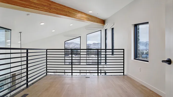 Upper-level loft overlooking living space in a Greenside penthouse apartment