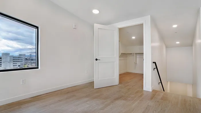 Loft space with railing and city views in a Greenside penthouse apartment