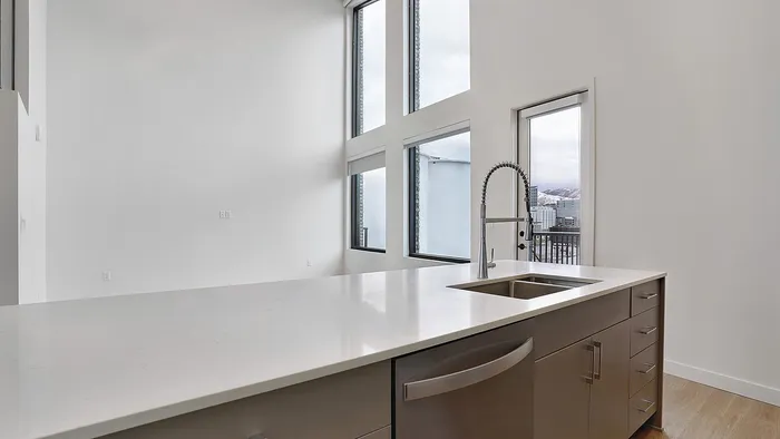 Living area with large windows and mountain views in a Greenside penthouse apartment