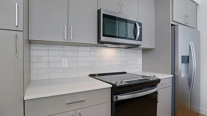 Open-concept penthouse kitchen with modern finishes at Greenside