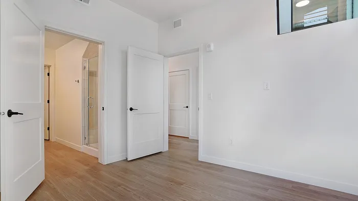 Alternate view of a primary bedroom in a Greenside penthouse