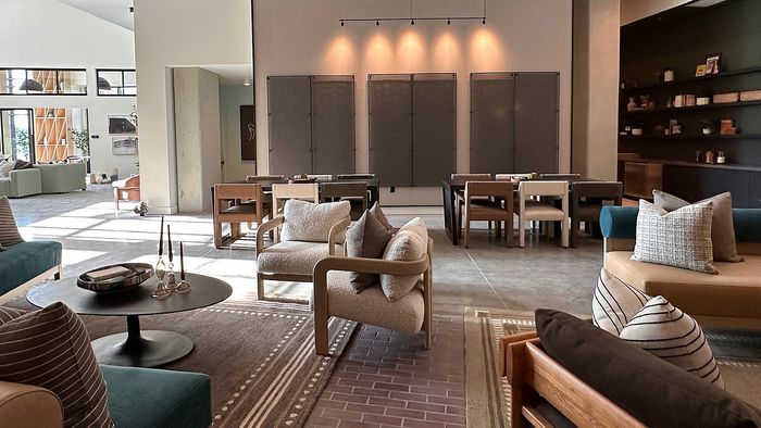 Spacious resident lobby with lounge seating, community tables, and modern industrial design.