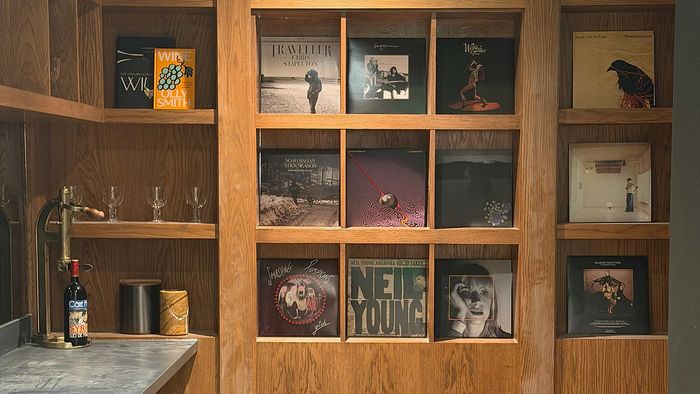 Resident speakeasy lounge with wood shelving, record collection, and stylish entertainment space.