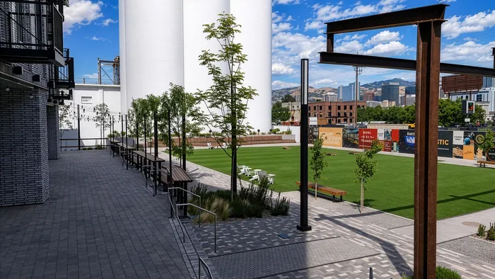 This courtyard view of Silo Park highlights the warmth and character of the community. Landscaped courtyards, distinctive architecture, and industrial landmarks create a setting that feels both refined and rooted in the Granary District&rsquo;s history, a neighborhood designed to feel vibrant, connected, and distinctly Salt Lake City.
