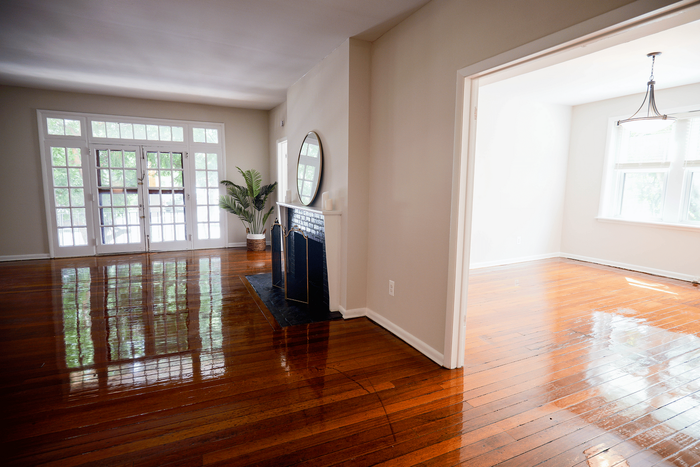 Comfortable and elegant living space with expansive windows and hardwood flooring at Sevilla Court.