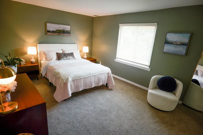 Inviting bedroom with elegant decor, featuring a cozy bed, stylish nightstands, and warm lighting accents.