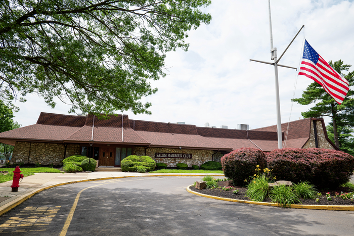 Welcome to the charming Salem Harbour Clubhouse, featuring beautiful stone architecture and well-maintained landscaping, perfect for community gatherings.