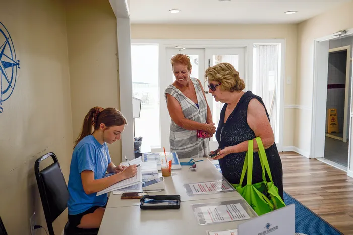 Welcoming reception area with friendly staff assisting guests, creating a warm and inviting atmosphere.