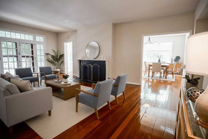 Charming and spacious living area with plush seating, elegant fireplace, and bright dining space, offering a warm and inviting atmosphere.