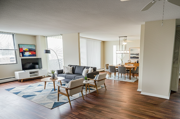 Elegant open-concept living and dining area featuring modern furnishings, natural light, and stylish decor.