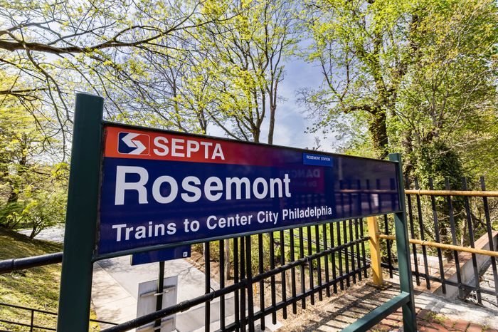 Inviting SEPTA station sign for Rosemont, showcasing lush greenery and a pathway to Center City Philadelphia.