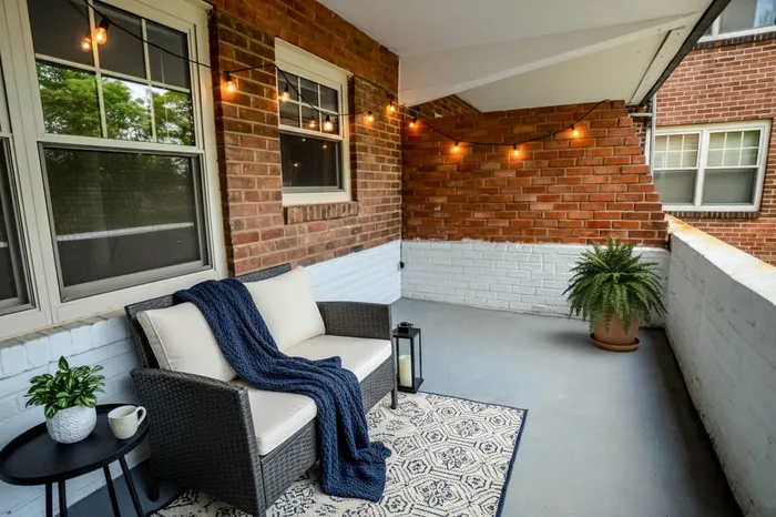 Charming and cozy outdoor patio with elegant string lights, comfortable seating, and lush greenery.