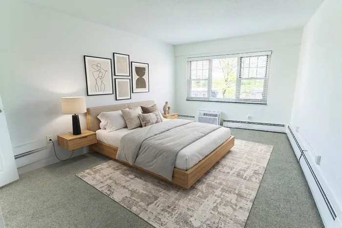 Bright and modern bedroom featuring a stylish bed, elegant artwork, and large windows with natural light.