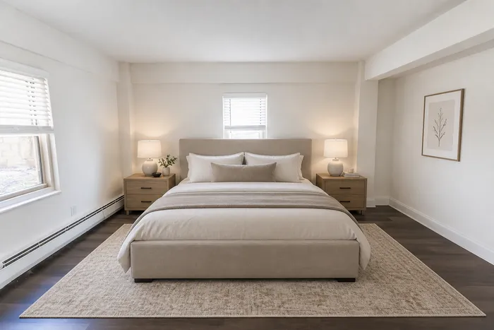Elegant bedroom with a plush king-size bed, soft lighting from bedside lamps, and cozy decor for a serene retreat.