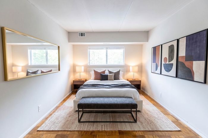 Elegant bedroom with modern decor, featuring a cozy bed, stylish artwork, and soft lighting for a welcoming atmosphere.