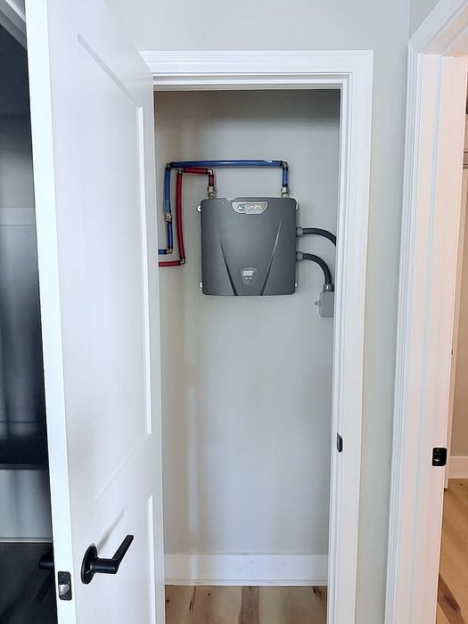 Efficient home utility closet showcasing a modern tankless water heater, optimizing space and energy usage.