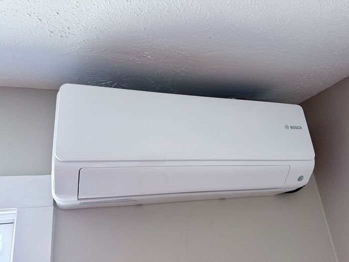 Elegant and efficient Bosch air conditioning unit seamlessly integrated into the apartment wall, ensuring a cool and comfortable living space.