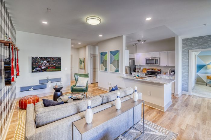 living room with kitchen in background