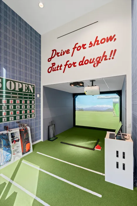 Chic indoor golf simulator featuring a golf-themed wall design and putting area.