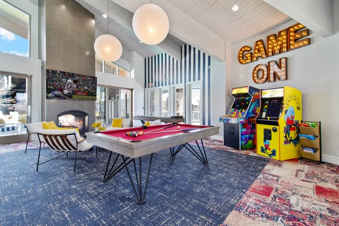 game room with pool table and arcade games