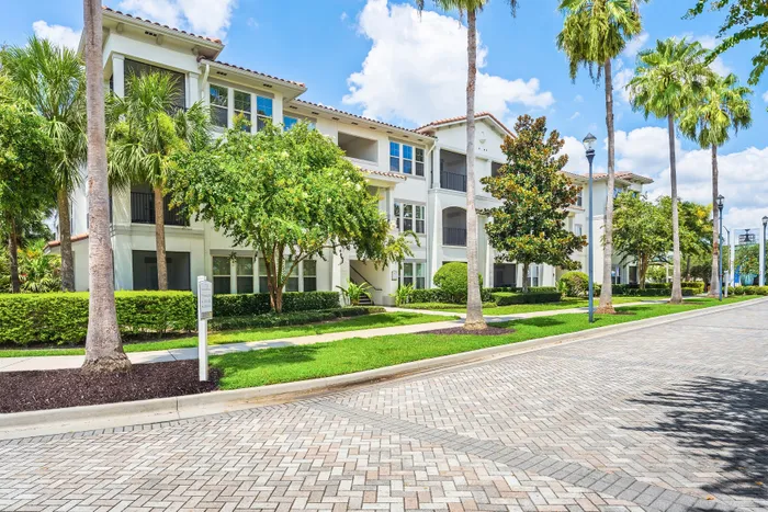 entry way with buildings and palm trees