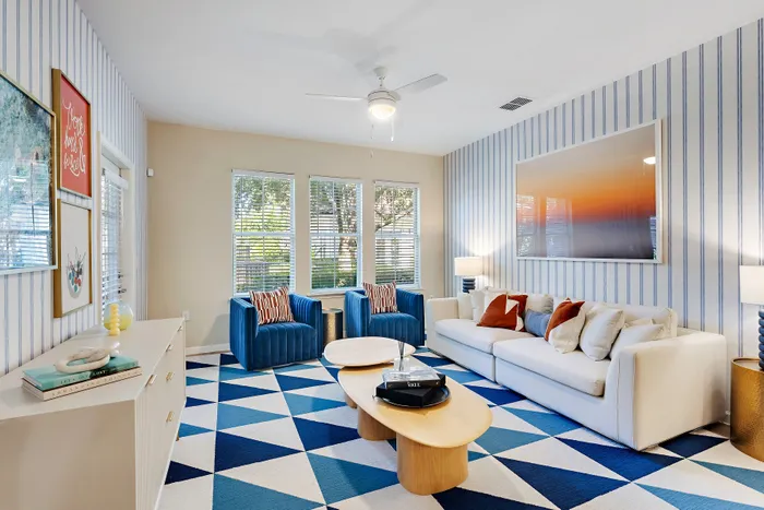 living room with bright furniture and windows in background