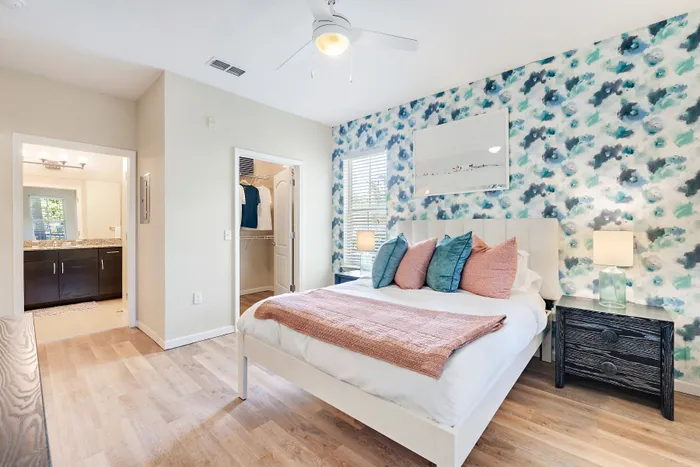 bedroom with white comforter and pink blanket