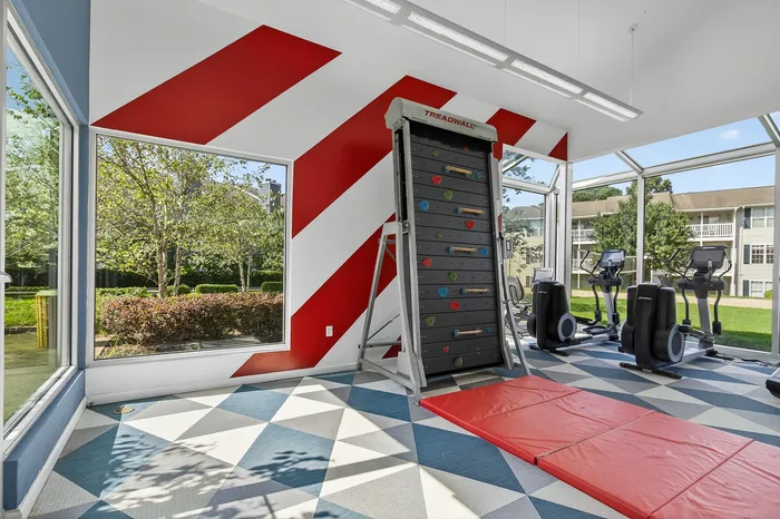 fitness center with weights and climbing wall