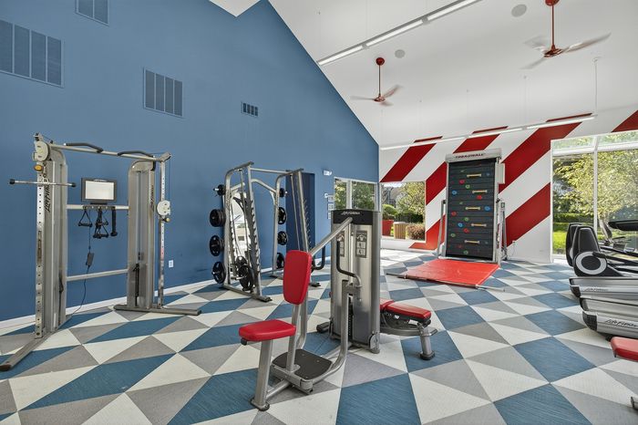 fitness center with weights and colorful carpet