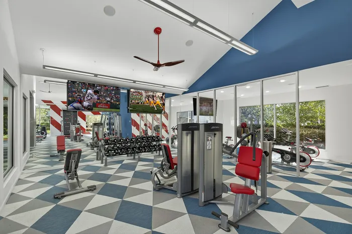 fitness center with weights and colorful carpet