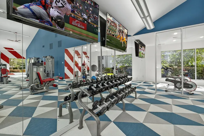 fitness center with weights and colorful carpet